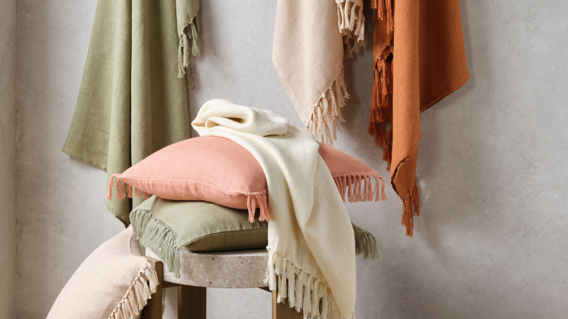 KOO Assorted pillows and blankets with tassle details KOO Assorted pillows and blankets with tassle details