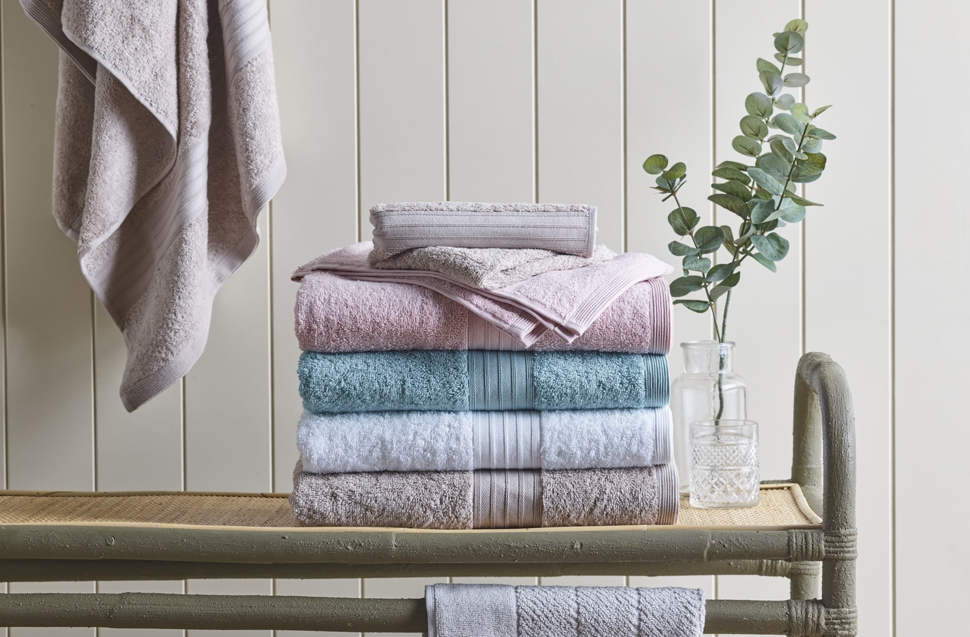KOO Bath Towels folded and stacked on a bathroom bench